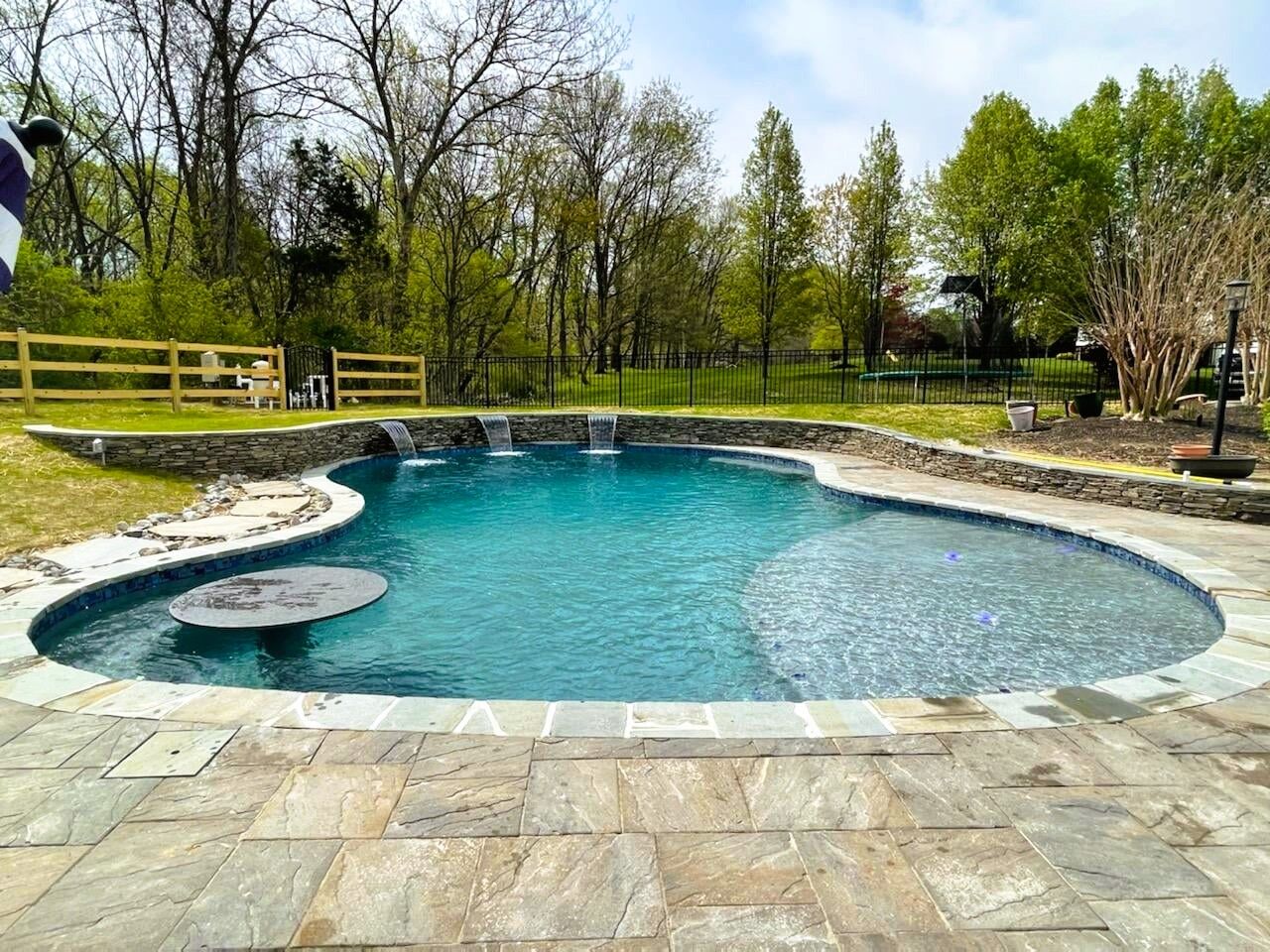 free-form-pool-tanning-ledge-swim-up-bar-and-waterfalls