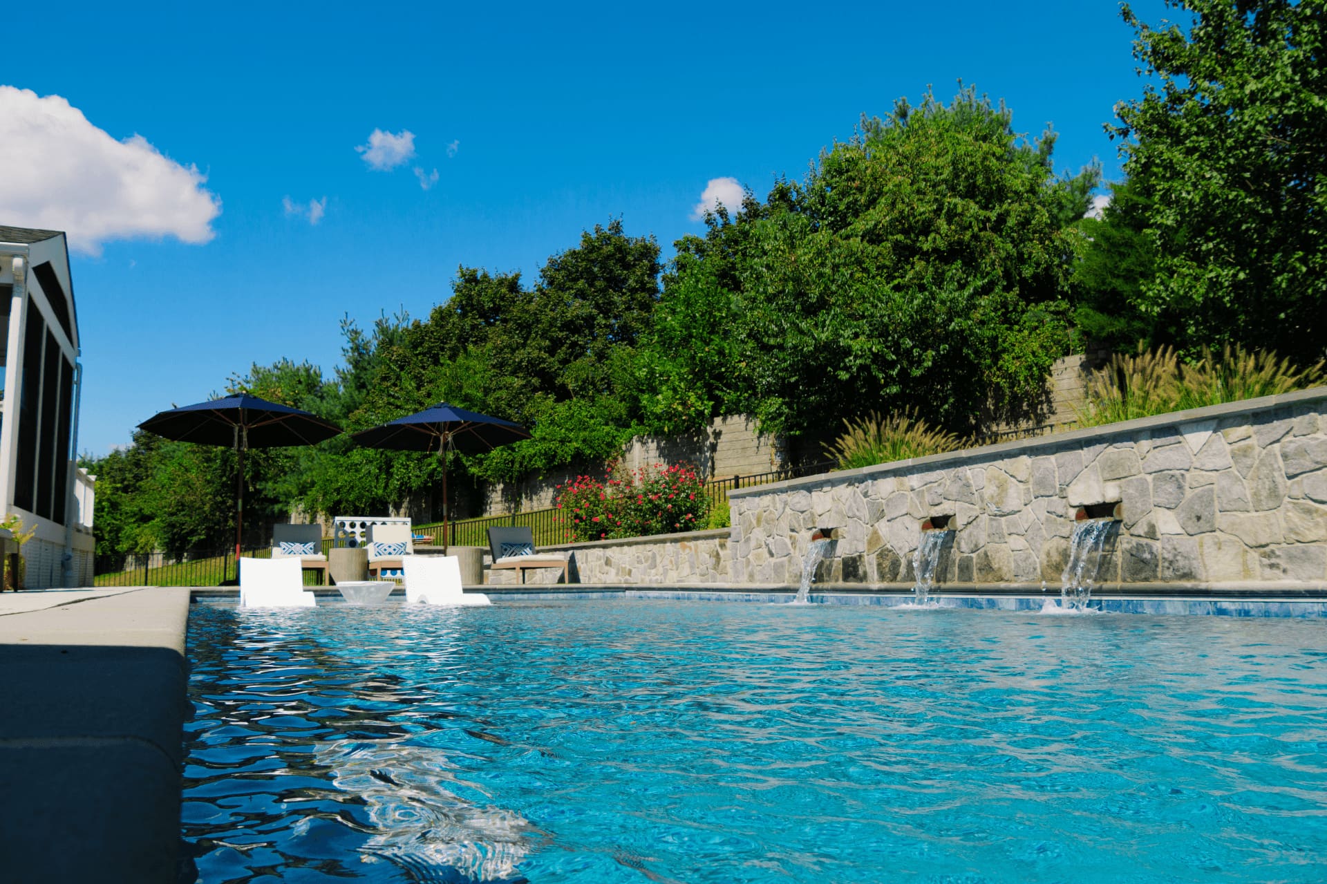custom geometric pool showing tanning ledge and pool scuppers