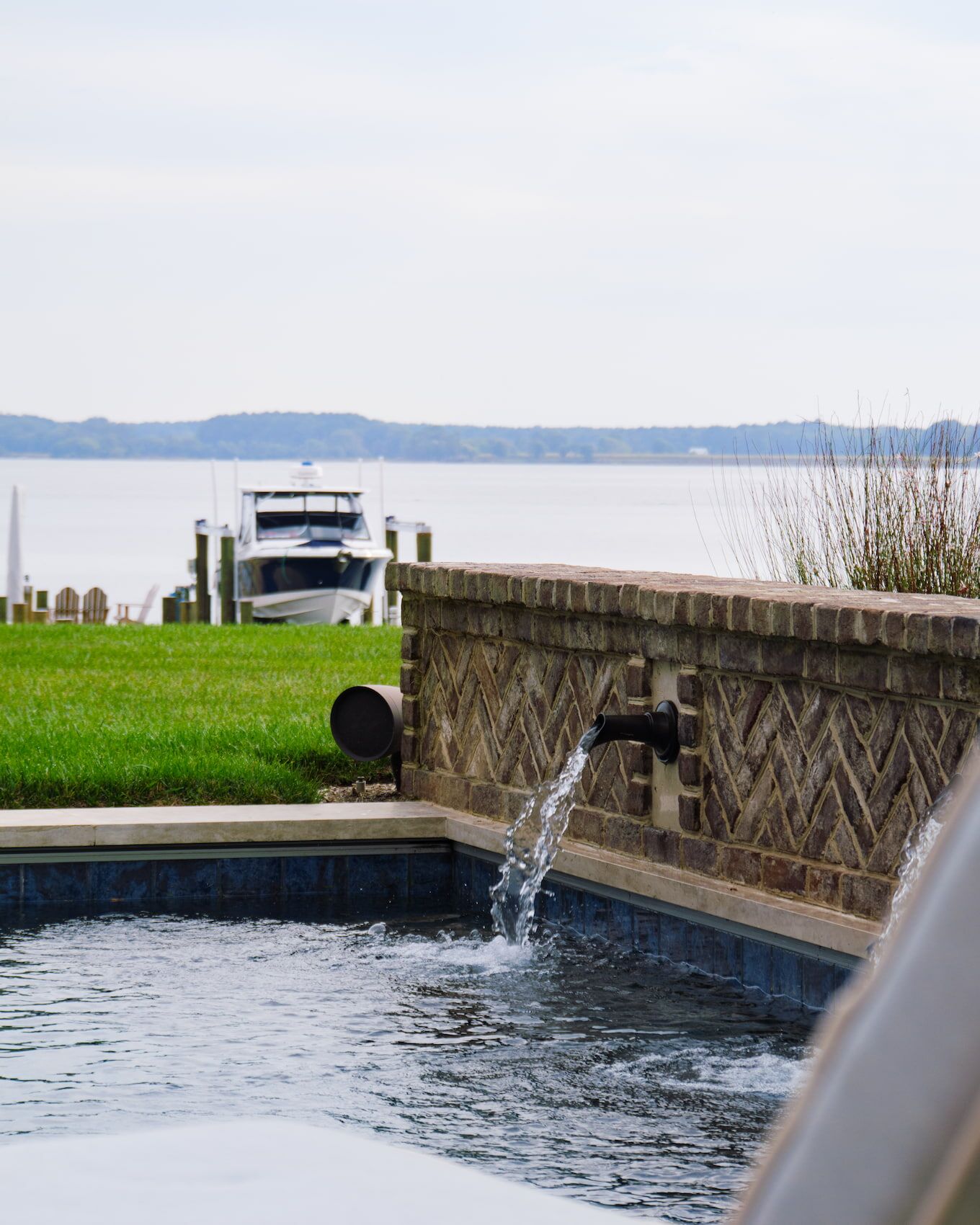 close-up of water falling from pool scupper