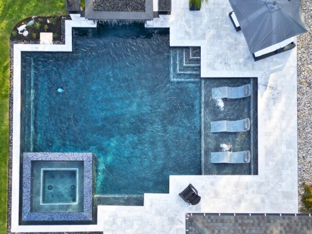 geometric pool with spa and tanning ledge