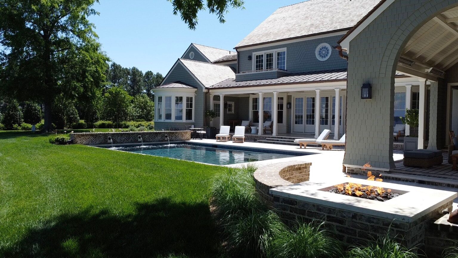 geometric pool with water features and fire pit