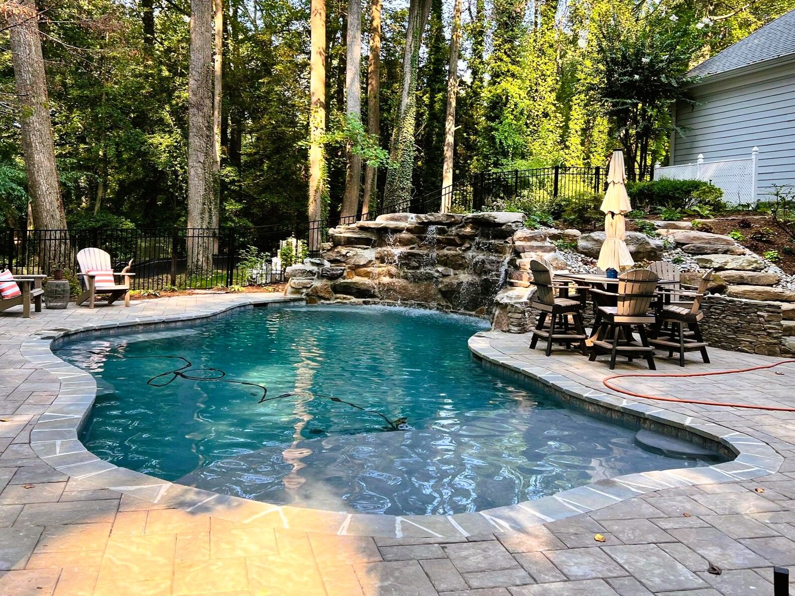 freeform pool with beautiful waterfall over boulders
