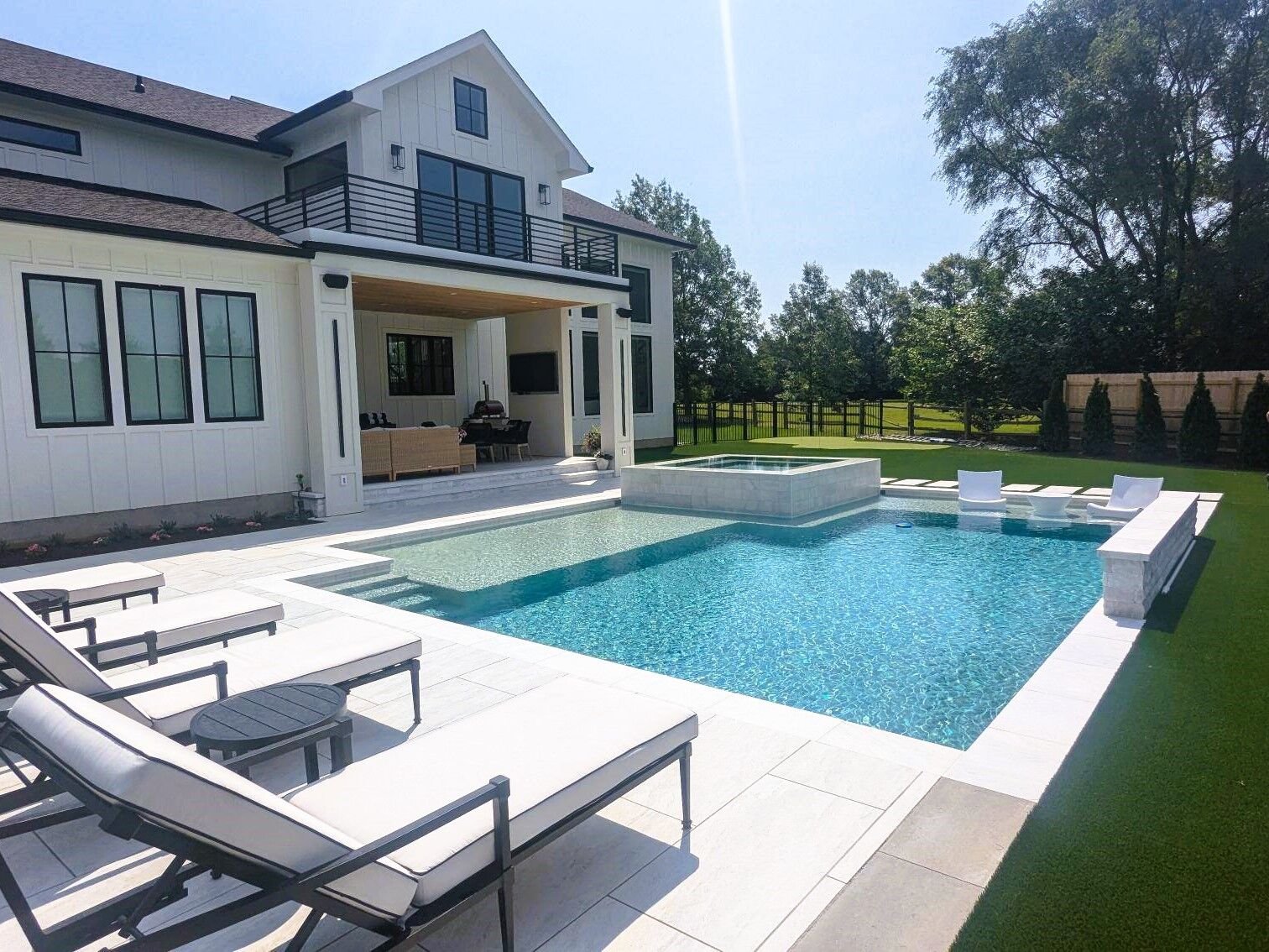 geometric pool with attached spa and tanning ledge