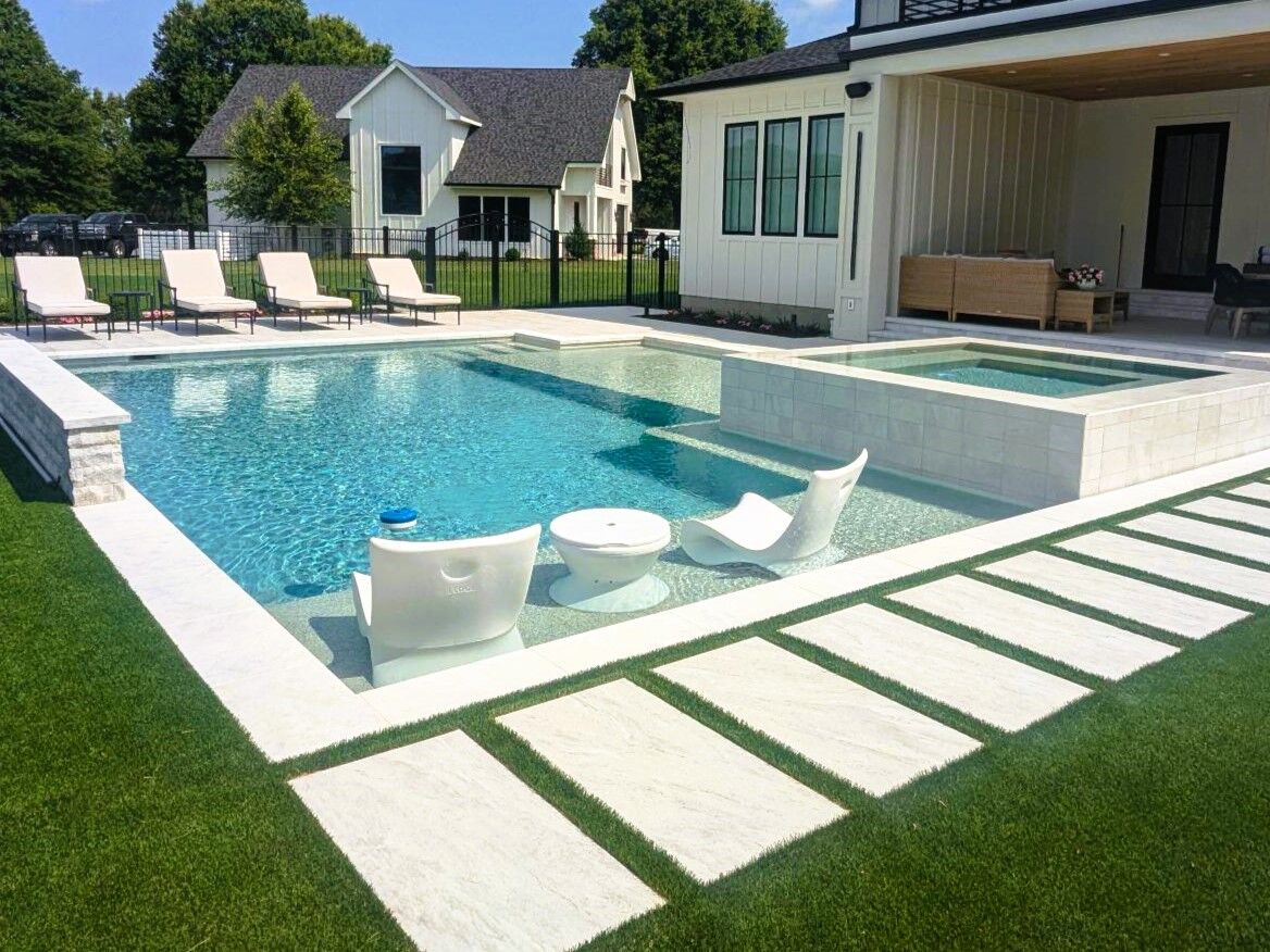 geometric pool with attached spa and tanning ledge