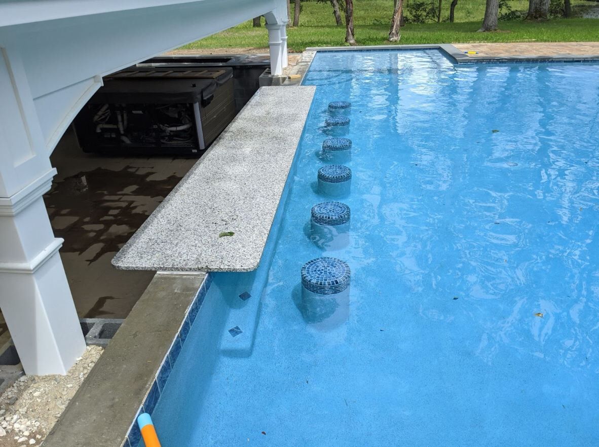 swim-up-bar with submerged seating within the swimming pool