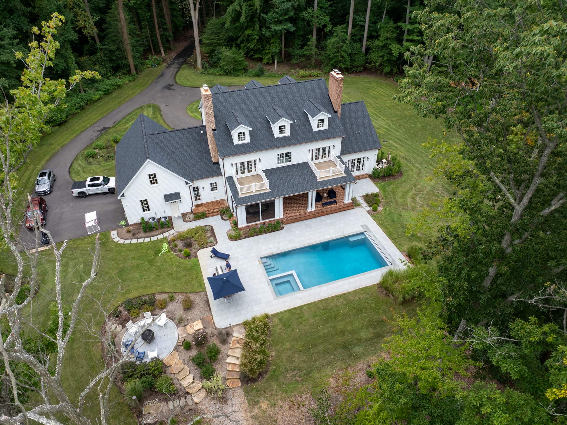 p348-aerial-1 aerial view of backyard showing pool, spa, outdoor kitchen, and firepit