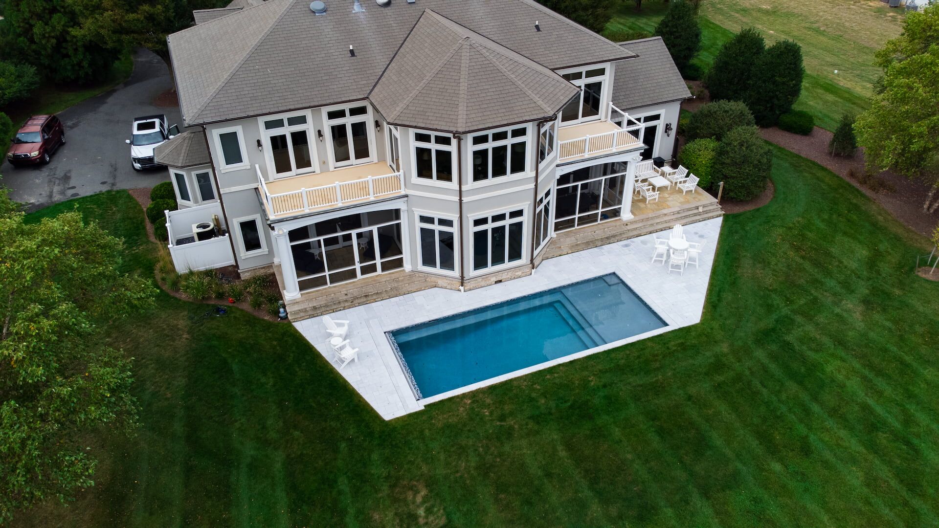 angled aerial view of geometric pool with tanning ledge