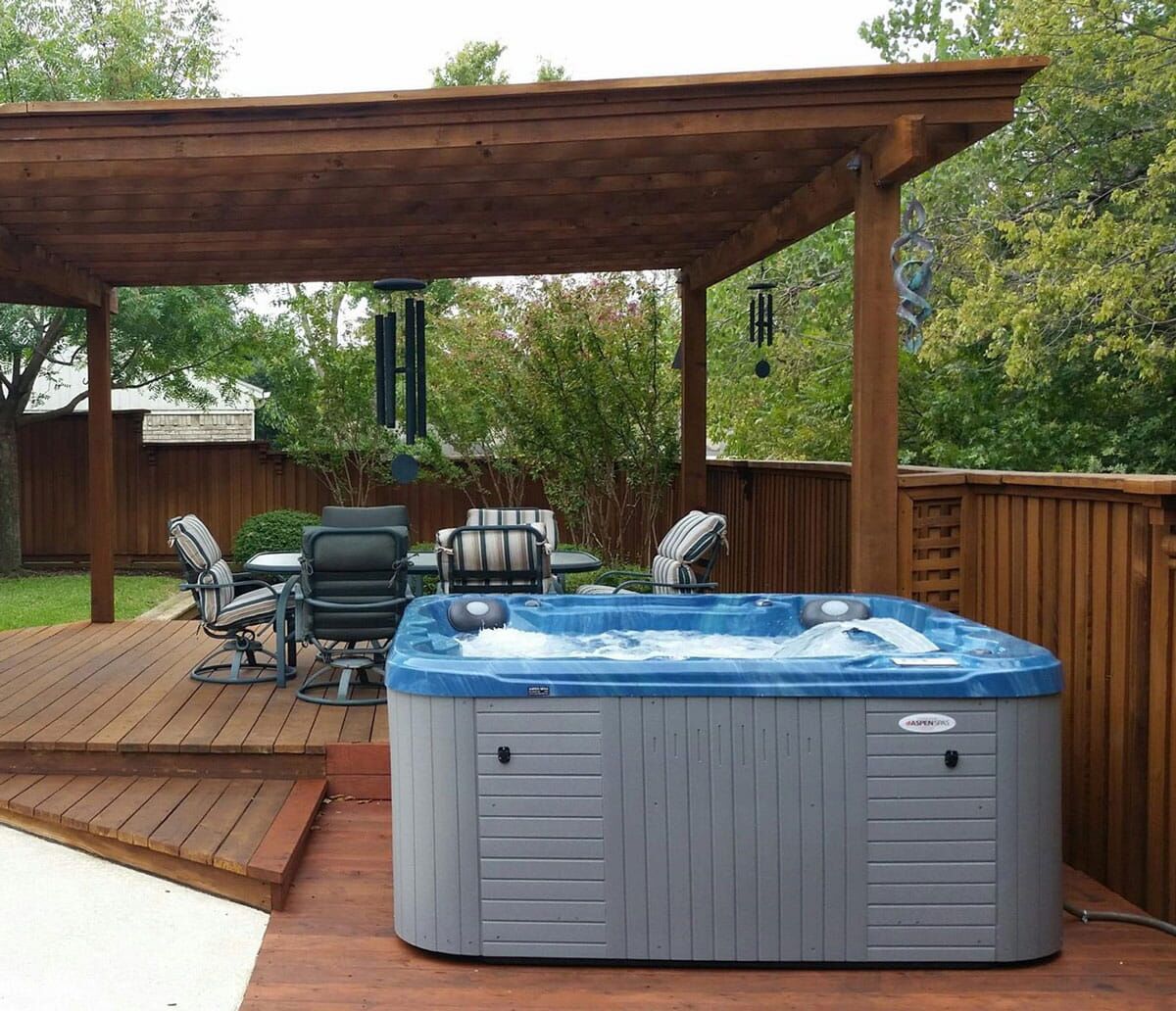 Hot tub on a wooden deck under a pergola