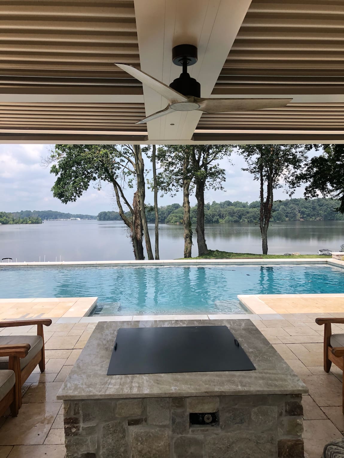 poolside fire pit and wet bar with geometric pool in background